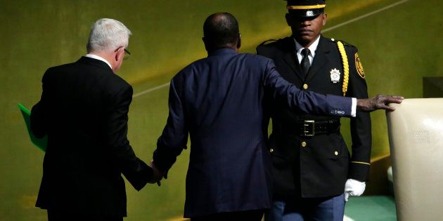 Zimbabwean President Robert Mugabe is assisted by a protocol officer (L) as he leaves the podium at 72nd United Nations General Assembly in New York this week. REUTERS/Eduardo Munoz