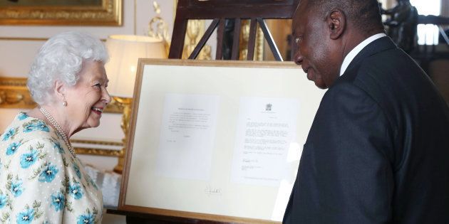 Britain's Queen Elizabeth II presents 1990s correspondence between herself and Nelson Mandela regarding South Africa's return to the Commonwealth as a gift to President Cyril Ramaphosa during an audience at Windsor Castle, Berkshire on April 17, 2018, on the sidelines of the Commonwealth Heads of Government meeting.