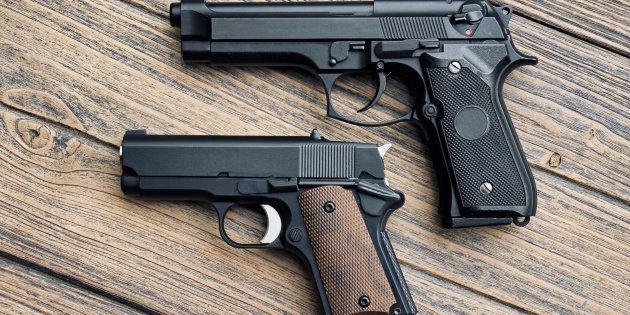 Two different hand guns: .45 pistol small guns.