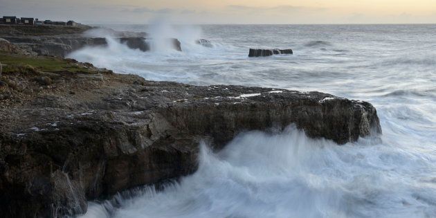 Spring tides bring waves crashing over rocks