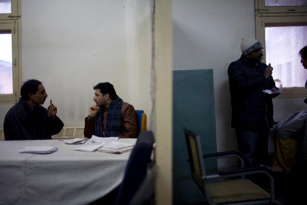 Kashmiris see a government psychiatrist, Dr. Arshad Hussain, center, at the Out Patient Department of the Sri Maharaja Hari Singh, SMHS, hospital.