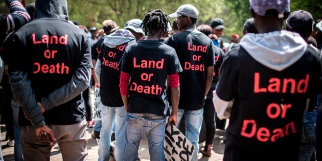 Members of Black First Land First (BLF) wear shirts with the text 'Land or Death' as they prepare to march to the offices of KPMG on Thursday in Johannesburg.