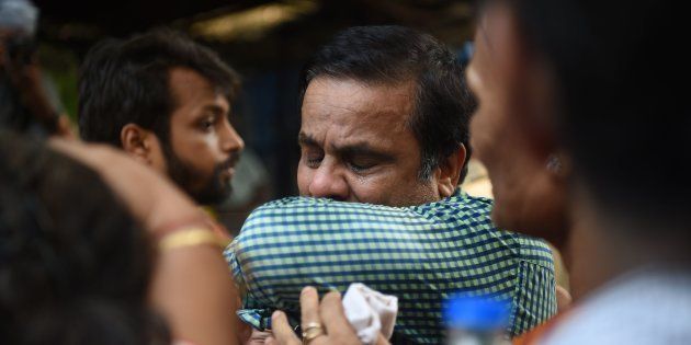 An Indian relative of a victim of a stampede on a railway bridge reacts outside a mortuary where bodies were being brought in Mumbai on September 29, 2017.