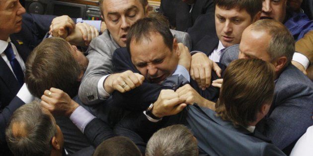 Deputies of the Svoboda party fight with the members of Regions Party, party of former Ukrainian President Viktor Yanukovych, during the debates in the parliament, the Verkhovna Rada, in Kiev on July 22, 2014.
