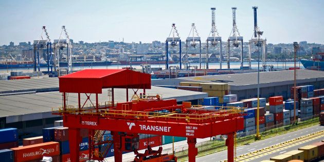 A crane operator unloads shipping containers from freight wagons at the Port of Durban, operated by Transnet SOC Holdings Ltd.'s Ports Authority, in Durban, South Africa, on Wednesday, Oct. 28, 2015.