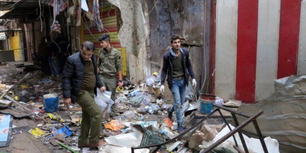 Iraqi security forces gather at the site of a bomb attack at a market in central Baghdad, Iraq December 31, 2016.