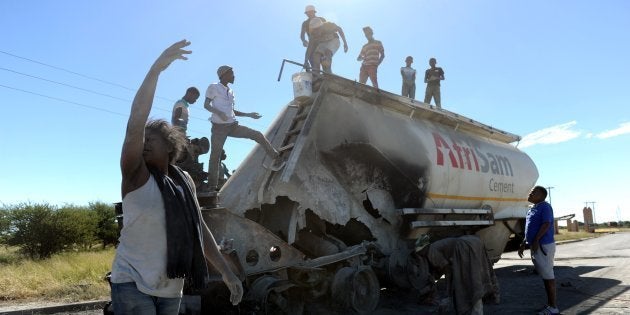 People are pictured after clashes with South African police on April 20, 2018, as protest continued for a second day in the northwestern province capital of Mahikeng.