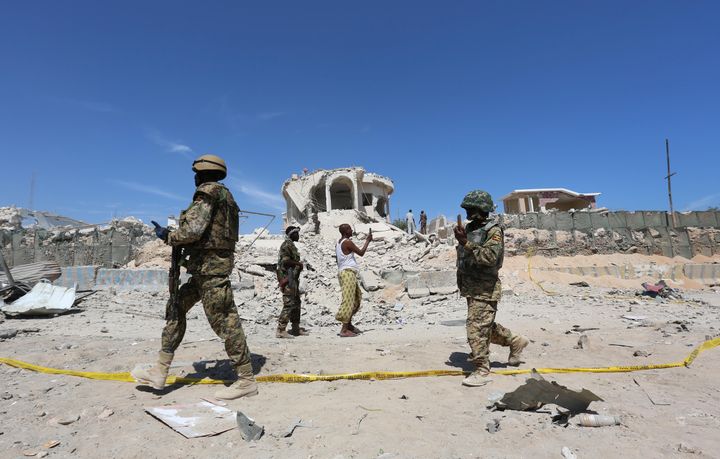 Ugandan soldiers serving in the African Union Mission in Somalia (AMISOM) walk at the scene of an explosion after a suicide attack at a checkpoint outside the main base of an African Union peacekeeping force in the Somali capital Mogadishu, January 2, 2017.