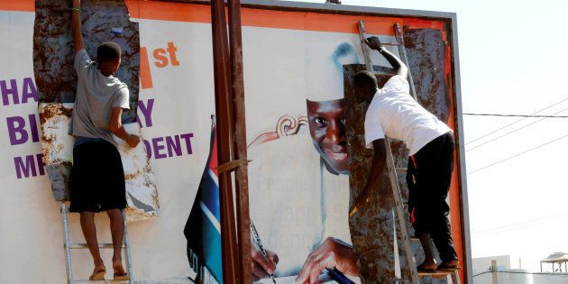 People tear a poster of former Gambian president Yaya Jammeh in Broussbi, Gambia, on December 4, 2016. Jammeh has refused to accept his election defeat.