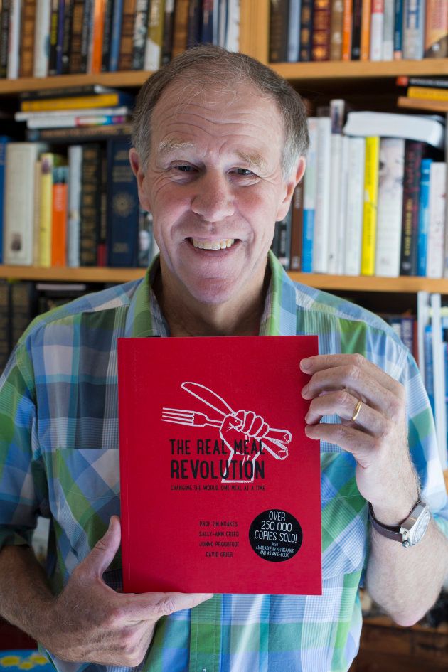 Tim Noakes, a South African scientist and an emeritus professor in the Division of Exercise Science and Sports Medicine at the University of Cape Town, holds his book the real meal revolution in his home office on August 10, 2016, in Constantia, outside Cape Town, South Africa.