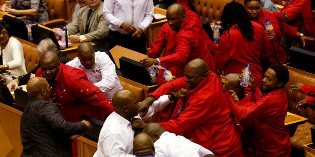 Party leader Julius Malema and members of his Economic Freedom Fighters (EFF) clash with Parliamentary security as they are evicted from the chamber in Cape Town, South Africa, May 17, 2016. REUTERS/Mike Hutchings