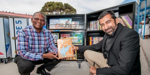New Africa Education Foundation's Ahmed Motala (right) hands over mobile libraries to the principal of Kama Primary School.
