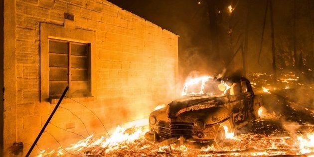 A car and a house burns on Tuesday, 3 January 2017 on the Helderberg Mountains outside Somerset West.