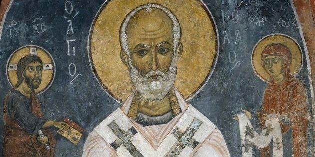 St. Nicholas of Myra is seen in this 12th-century fresco. The saint's acts of generosity, particularly to children, inspired the red and white-suited figure known as Santa Claus.