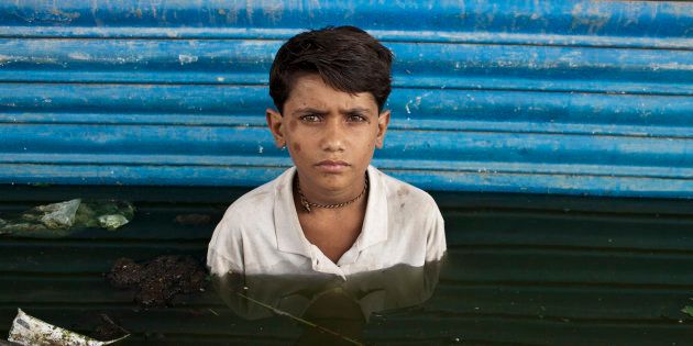 Young Asif is photographed in the town of Khairpur Nathan Shah, which was submerged by flood waters.