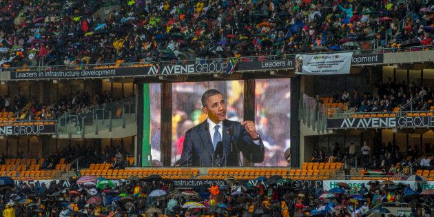 Then-U.S. president Barack Obama speaks at the memorial for Nelson Mandela at the FNB stadium in Johannesburg