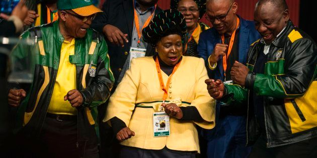 South African President Jacob Zuma (L), former African Union Chairperson and presidential hopeful Nkosazana Dlamini-Zuma (C) and South African Deputy President Cyril Ramaphosa (R) dance after the closing session of the South African ruling party African National Congress (ANC) policy conference on July 5, 2017 in Johannesburg, South Africa.