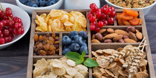 breakfast cereal and other ingredients in a wooden box, horizontal