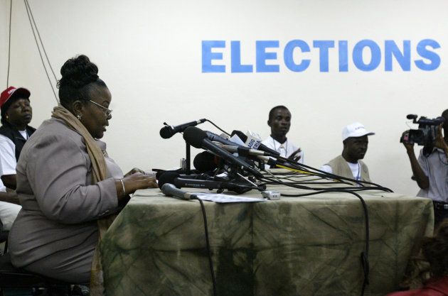 Frances Johnson-Morris (2nd L), head of the national electoral commission, gives a news conference at its headquarters in Monrovia on October 12, 2005.