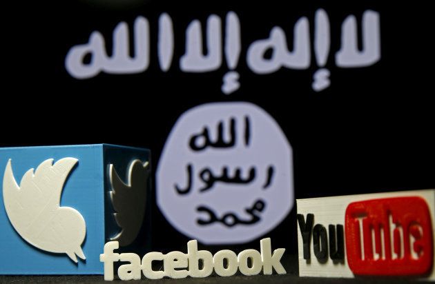 3D plastic representations of the Twitter, Facebook and Youtube logos are seen in front of a displayed ISIS flag in this photo illustration shot February 3, 2016.