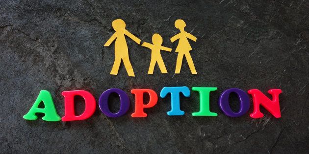 Paper family of three with adoption play letters.