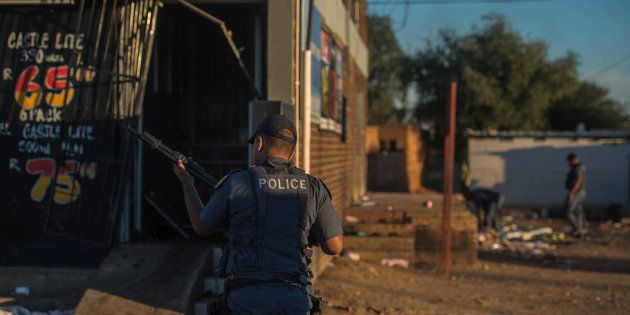 South African riot police fire rubber bullets to prevent looting in North West Province on April 20, 2018, as protests continued for a second day in Mahikeng.