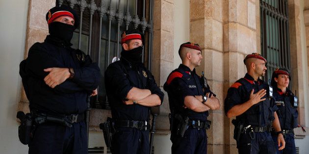 Mossos d'Esquadra, Catalan regional police officers, stand guard outside the Catalonian regional Parliament in Barcelona on October 10 2017.