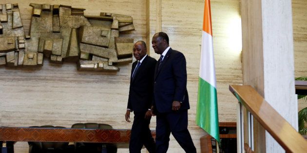 Ivory Coast President Alassane Ouattara (R) walks with the new Prime Minister Amadou Gon Coulibaly in the Presidential Palace in Abidjan, Ivory Coast January 10, 2017.
