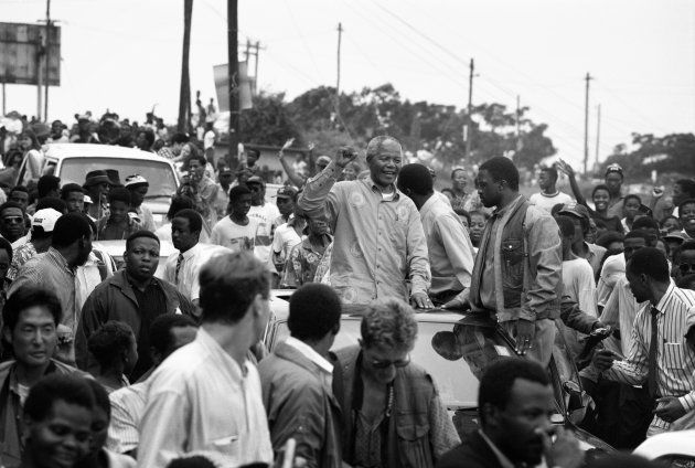 Nelson Mandela acknowledges a crowd of ANC supporters April 21, 1994 in Durban, South Africa. The pre-election rally is just days before the historic democratic election on April 27, 1994 that Mr. Mandela won. Mr. Mandela became the first black democratic elected president in South Africa. He retired from office after one term in June 1999. (Photo by Per-Anders Pettersson./Corbis via Getty Images)