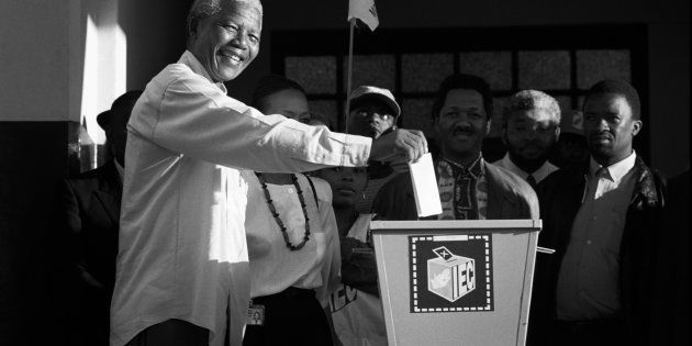 Nelson Mandela casts his historic vote in a small voting station on April 27, 1994 at Oshlange High School outside Durban.