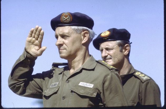 Head of the South African Defence Force General Constand Viljoen salutes (L) and Army Chief Lieutenant-General Jan Geldenhuys as troops withdraw from Angola into Nambia.