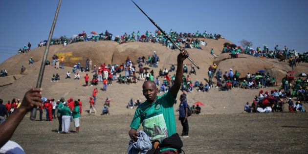 Miners and members of the Association of Mineworkers and Construction Union (AMCU) sing during the 5th-year-anniversary commemorations to mark the killings of 34 striking platinum miners shot dead by police outside the Lonmin's Marikana platinum mine in Rustenburg, South Africa August 16, 2017.