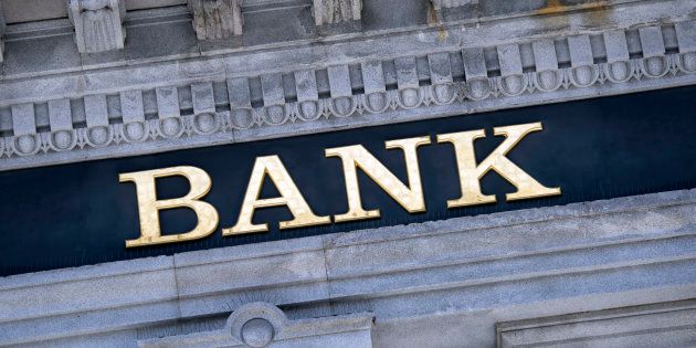 An old fashioned 'Bank' sign on a building exterior.