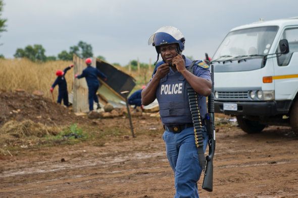 A police officer during a protest by Nellmapius on November 12, 2014 in Pretoria, South Africa. Metro police fired rubber bullets at residents who attempted a 'land grab.