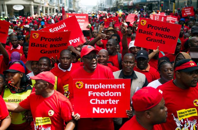 Former general secretary of Cosatu Zwelinzima Vavi (C) protests with members of the National Union of Metalworkers of South Africa (NUMSA) as they march through Durban. March 19, 2014.