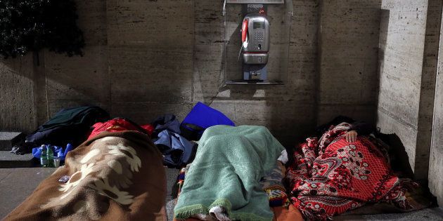 Homeless people sleep in passageway near St. Peter's square in Rome, Italy, on January 11, 2017. It takes half the world's poorest people to make up as much money as the world's eight richest men own.