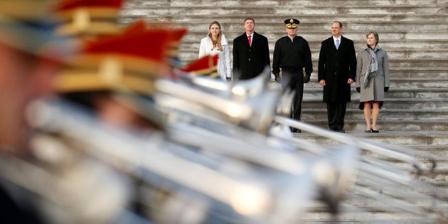 A military band passes stand-ins for U.S. President-elect Donald Trump and his wife Melania (L), and Vice President-elect Mike Pence and his wife Karen (R) during a rehearsal for the inauguration in Washington, U.S.