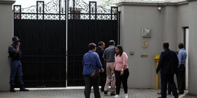 Members of the South African Asset Forfeiture Unit and other law enforcement agencies arrive to search the Gupta family compound on April 16, 2018 in Johannesburg.