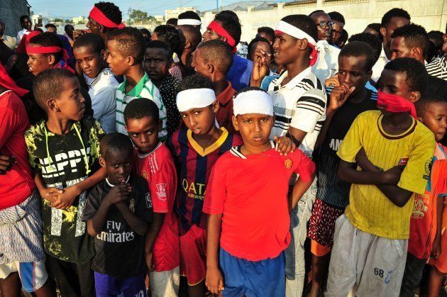 People wear headbands as a sign of anger as they protest against the deadly bomb attack in Mogadishu on October 15, 2017, after a truck bomb exploded outside of the Safari Hotel on a busy road junction, levelling buildings and leaving many vehicles in flames.