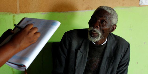 Former gold miner Senzele Silewise, 81, talks to paralegals in Bizana in South Africa's impoverished Eastern Cape province March 7, 2012. Silewise worked underground in the country's gold mines for 44 years before being diagnosed with silicosis.