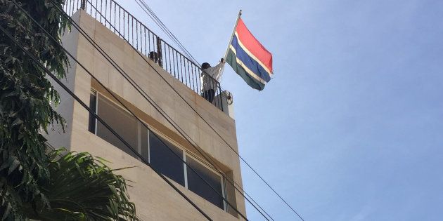 Officials at The Gambia embassy hoist up a new flag ahead of the inauguration of Gambia's President-elect Adama Barrow in Dakar, Senegal, January 19, 2017. REUTERS/Emma Farge