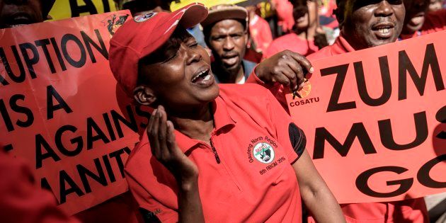 Cosatu members cheer and dance as they march through the streets protesting against corruption on September 27, 2017 in Johannesburg.