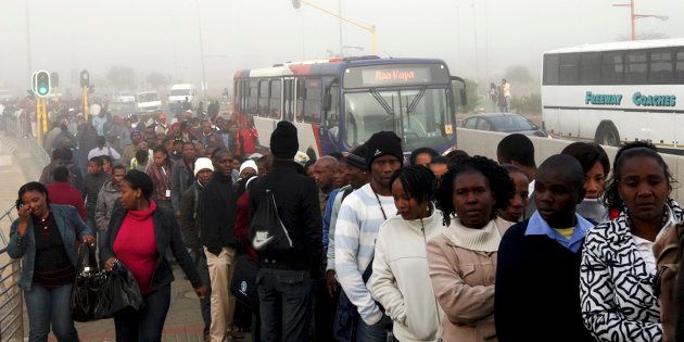 Commuters wait to board a bus during a strike in Soweto May 17, 2010.