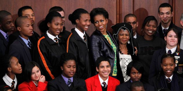 U.S. first lady Michelle Obama stands with former Managing Director of the World Bank Mamphela Ramphele (5th R) and high school students after answering students' questions at the University of Cape Town in Cape Town June 23, 2011.