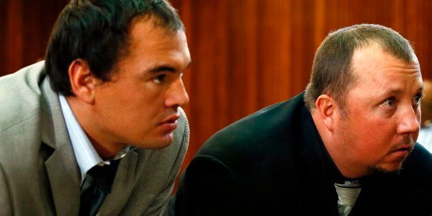 Willem Oosthuizen (L) and Theo Martins Jackson (R) look on during proceedings at The Middelburg Magistrate Court in Mpumalanga on August 25, 2017.