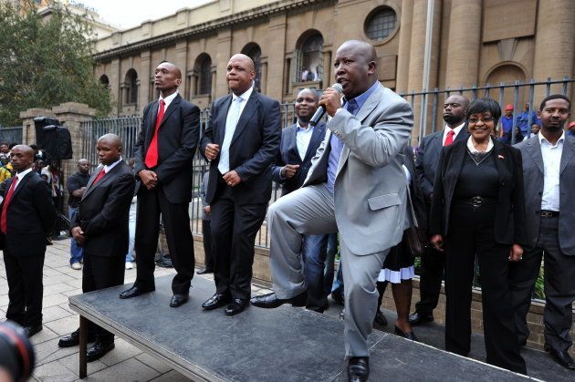 Julius Malema dances while addressing supporters outside the High Court in Johannesburg during his trial for hate speech.