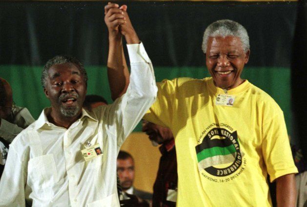 Nelson Mandela and Thabo Mbeki celebrate Mbeki's election as President of the ANC in Mafikeng, December 17, 1997. REUTERS/Stringer