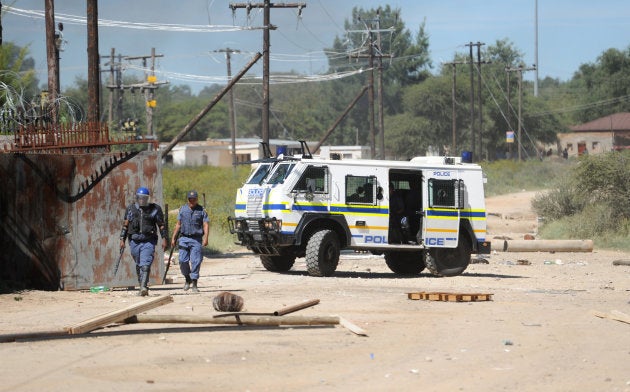 Police walks after residents and protesters clashed with the South African police in North West Province on April 20, 2018, as protest continued for a second day in the northwestern province capital of Mahikeng.