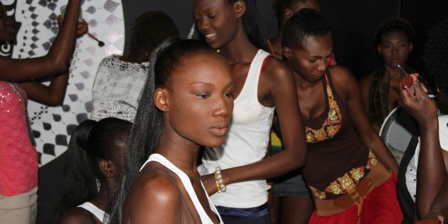 Models prepare for a show backstage during Dakar Fashion Week, June 20, 2013. Senegal's marquee fashion event, took a stand that year against the damaging practice of skin bleaching by banning any models using skin depigmentation cream from participating in the six-day event.