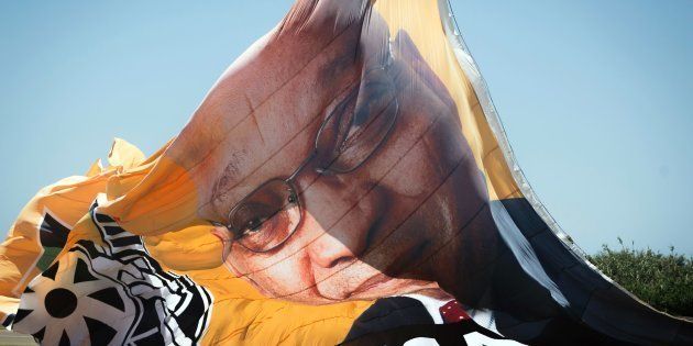 A photo shows a flag of the African National Congress (ANC) with a portrait of President Jacob Zuma before it is flown over New Year's day revellers and holidaymakers on Durban Beach during New Year festivities in Durban on January 1, 2017.